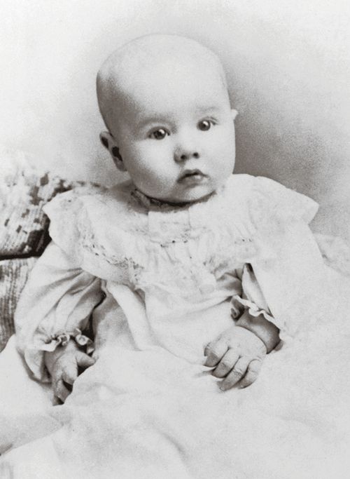 Ezra Taft Benson as a baby in a white gown, with wide eyes and minimal hair, dated 1900.