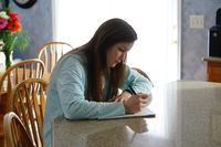 young woman writing goals