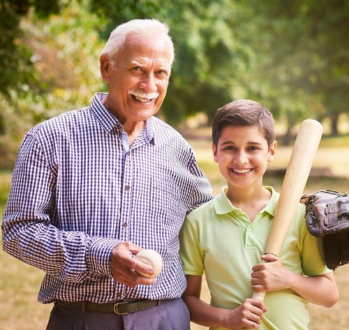 grandfather playing baseball with grandson