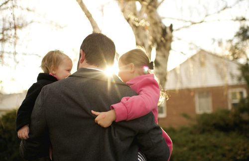 dad holding children