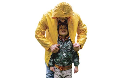 father in raincoat covering child