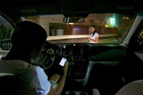 young man using cell phone in car