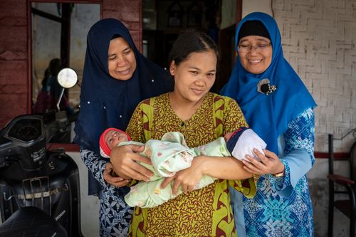 At a birthing center in Indonesia, women are being trained and prepared for birth and caring for their babies. 
Mother's hold their newborn babies.