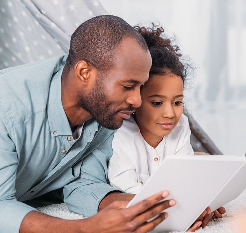 father reading to daughter