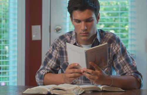 young man reading a booklet