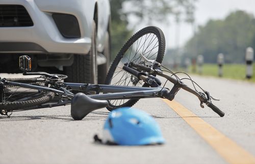 Bicycle and helmet in road