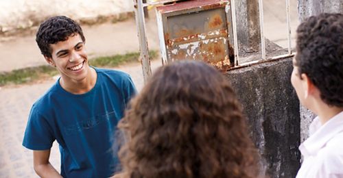 Young man  talking to people