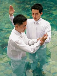 young man being baptized