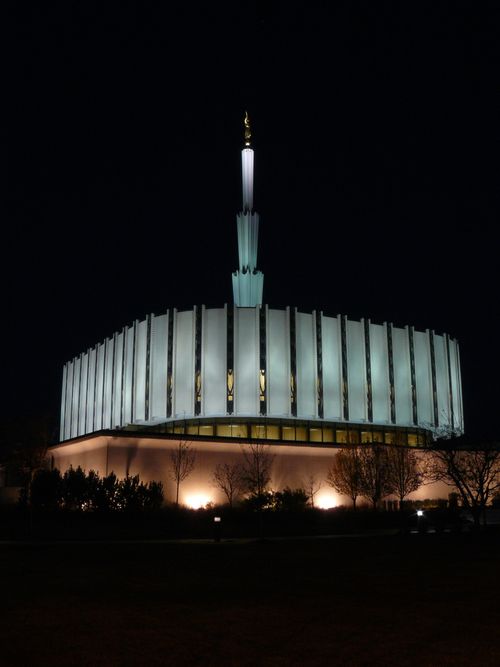 The old version of the Ogden Utah Temple, with the lights on at night and the black sky in the background.