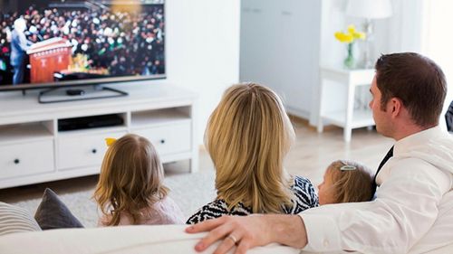 family watching general conference on tv