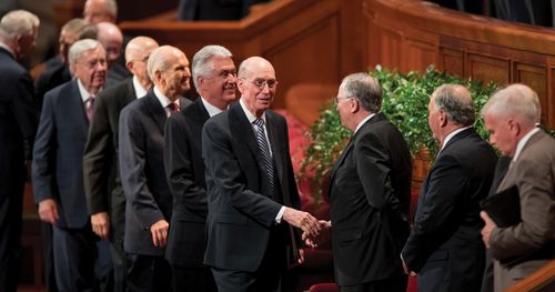 modern-day Apostles shaking hands with each other at general conference