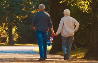 elderly couple walking together