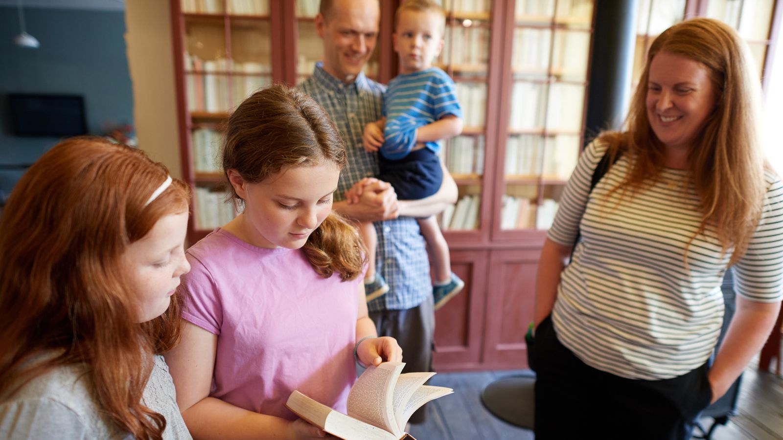 Various family members interact with various exhibits in the Book of Mormon Historic Publication Site (E. B. Grandin's Print Shop) in Palmyra, New York. Two girls appear to be reading a book.