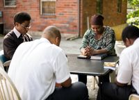 missionaries praying with investigator