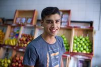 young man in front of fruit stand