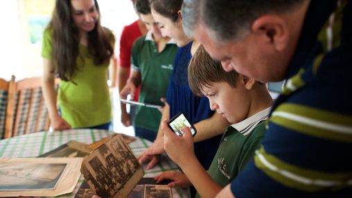 A family looking through old photographs together.