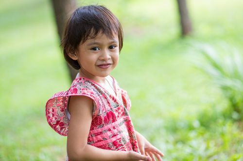 Informal outdoor portrait of a young Indonesian girl.