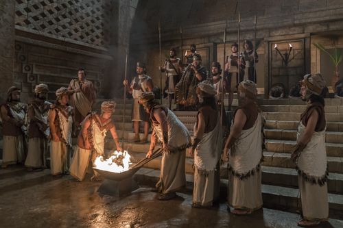 King Noah watches as guards light torches and Abinadi is put to death.