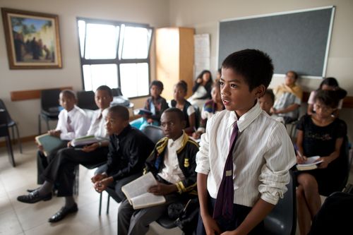 young boy standing in class