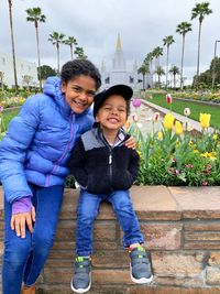 two siblings outside temple