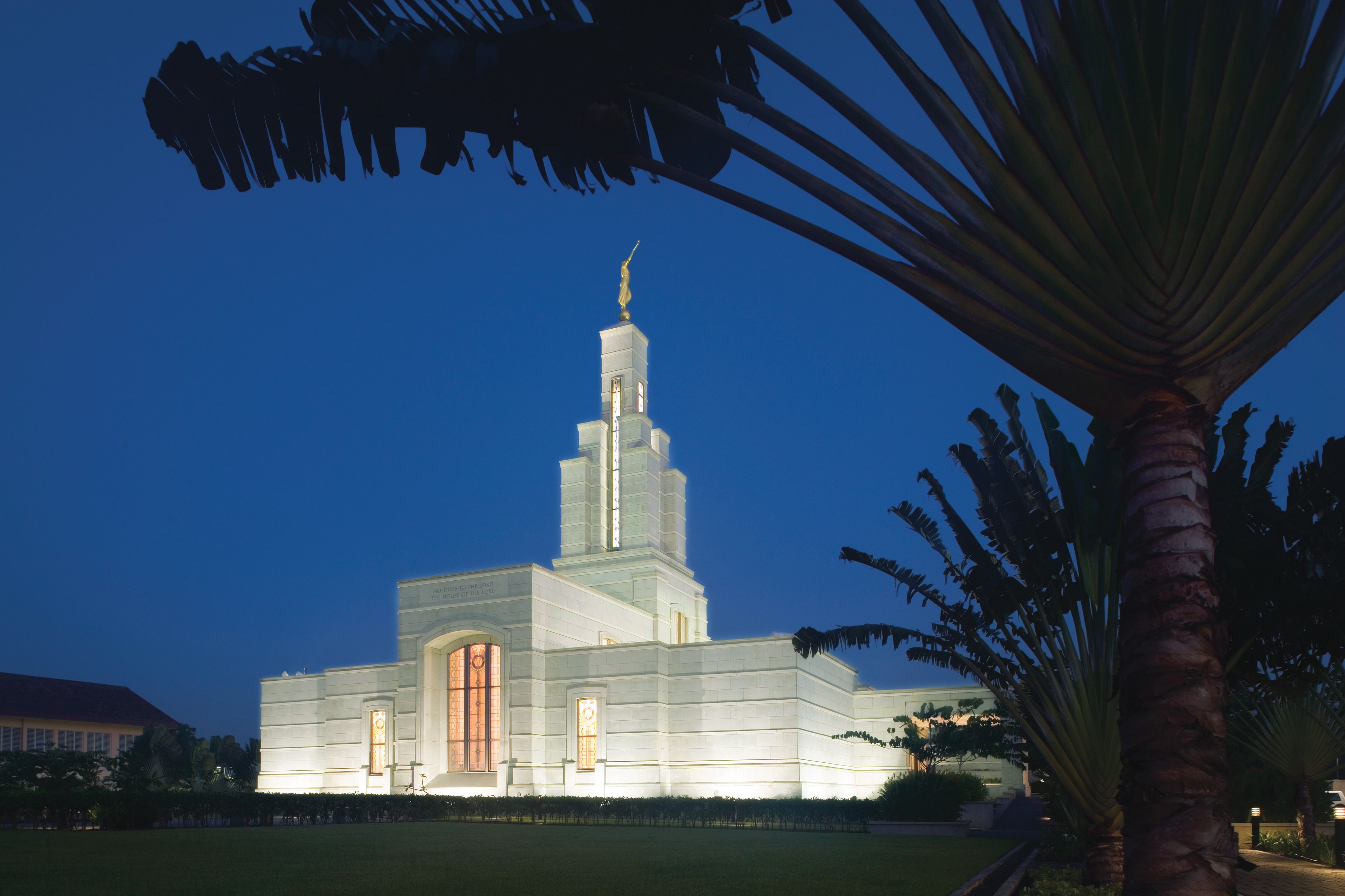 The Accra Ghana Temple is lit up at night.