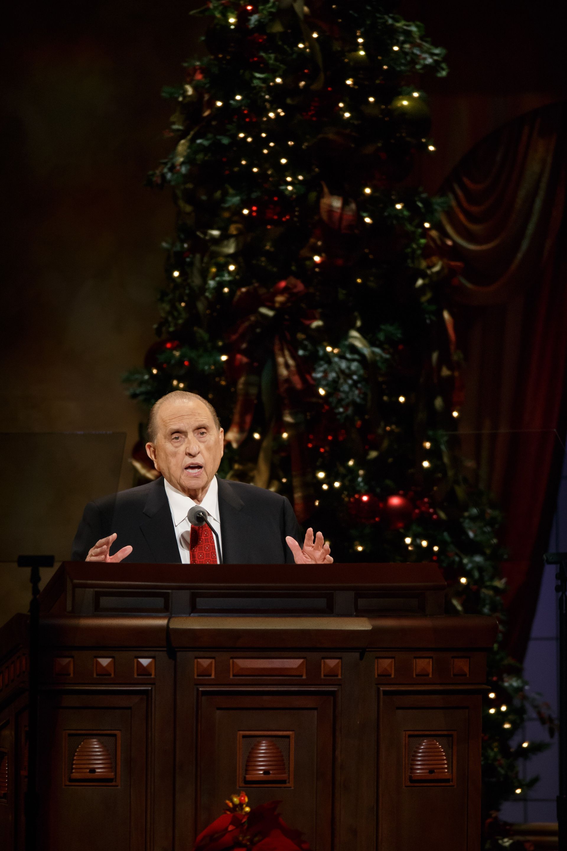 President Monson giving a talk at the First Presidency Christmas Devotional.