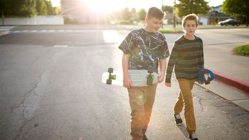 young men holding skateboards