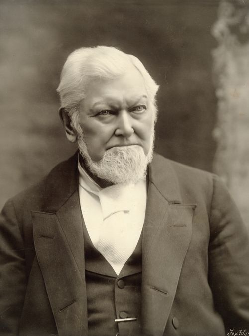 A black-and-white portrait photograph of Wilford Woodruff in a dark suit and white shirt.