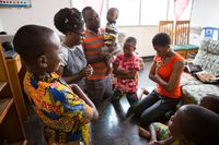 family kneeling in prayer