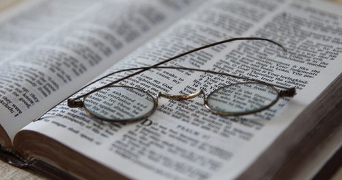 glasses on scriptures