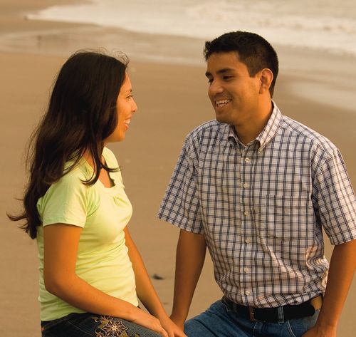 couple talking on beach at sunset