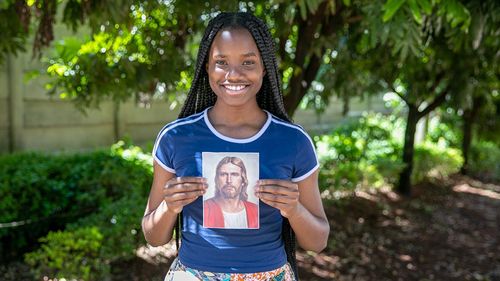 youth holding a picture of the Savior