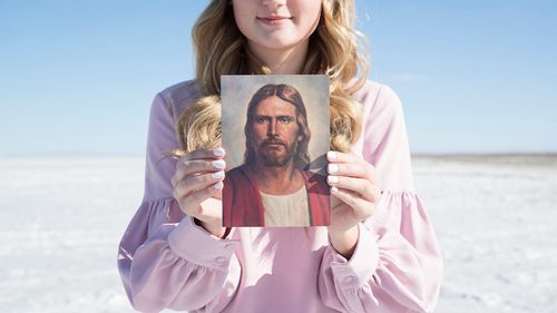 youth holding a picture of Jesus