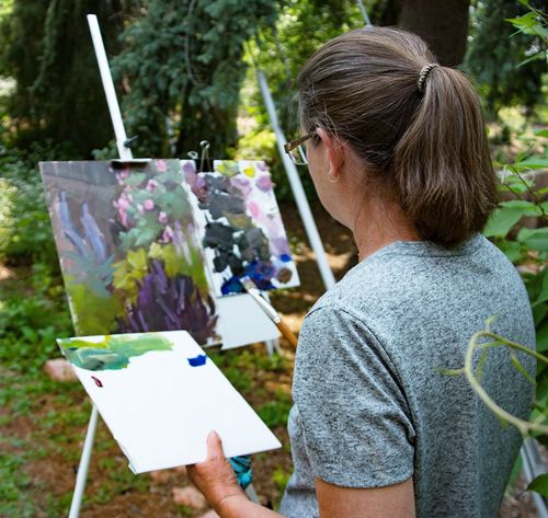 woman painting on canvas