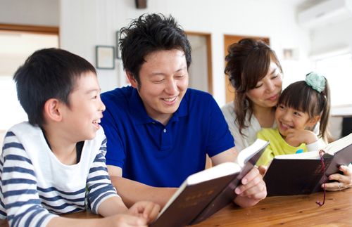 young family reading scriptures together
