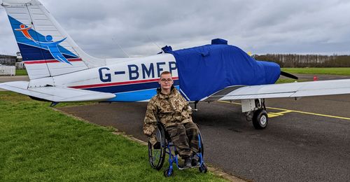 young man by airplane