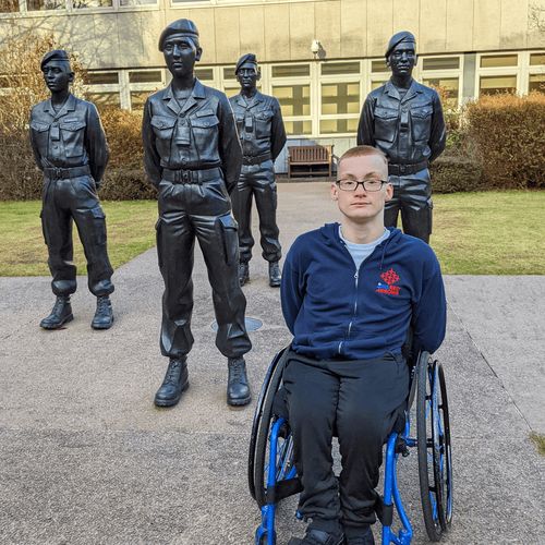 young man with statues of soldiers