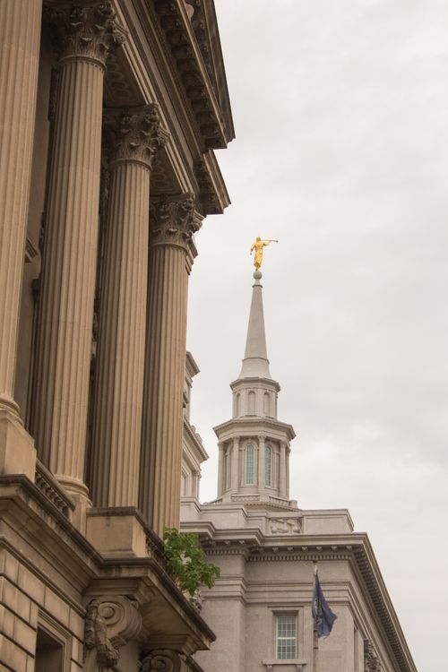 A side exterior view of the Philadelphia Pennsylvania and one of its spires with the Angel Moroni on top.