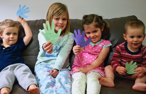 Children recorded acts of service on cutout hands