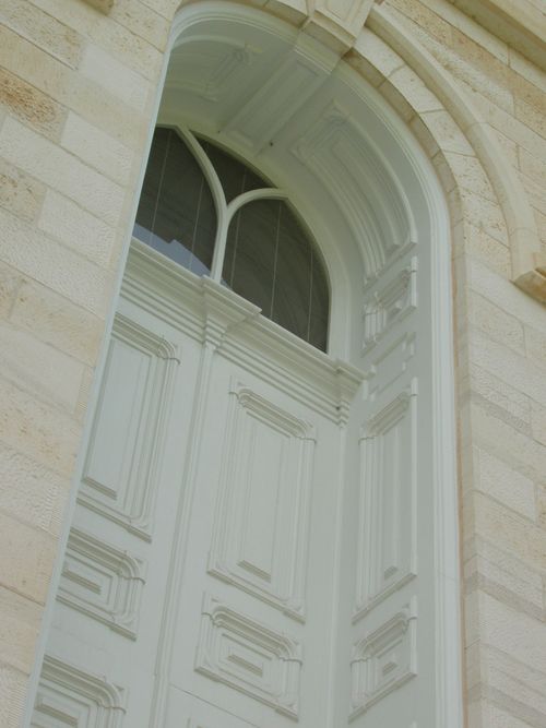 A close-up of a door on the Manti Utah Temple exterior, including arched windows.