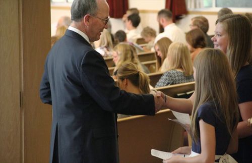 Young women greeting at church