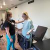 nurse helping a woman with physical therapy