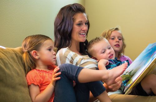 Mother reading with her children.