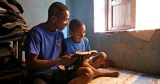 Father and son reading the scriptures