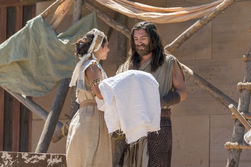 Nephi and his wife stand in front of the temple.