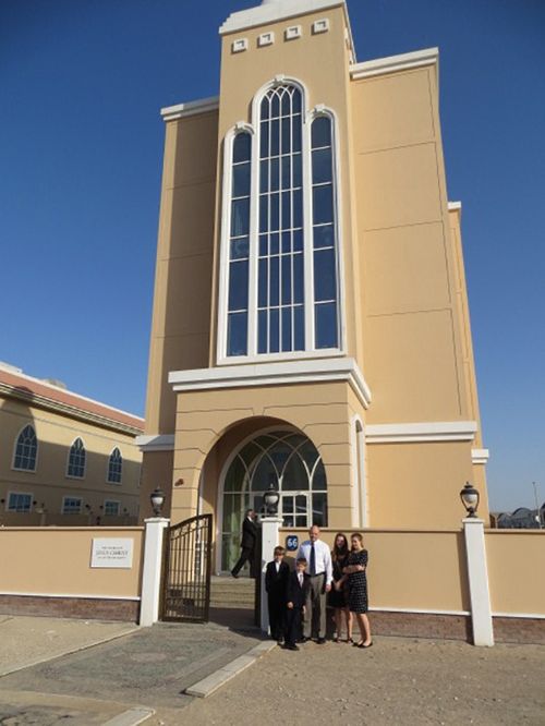 family in front of stake center