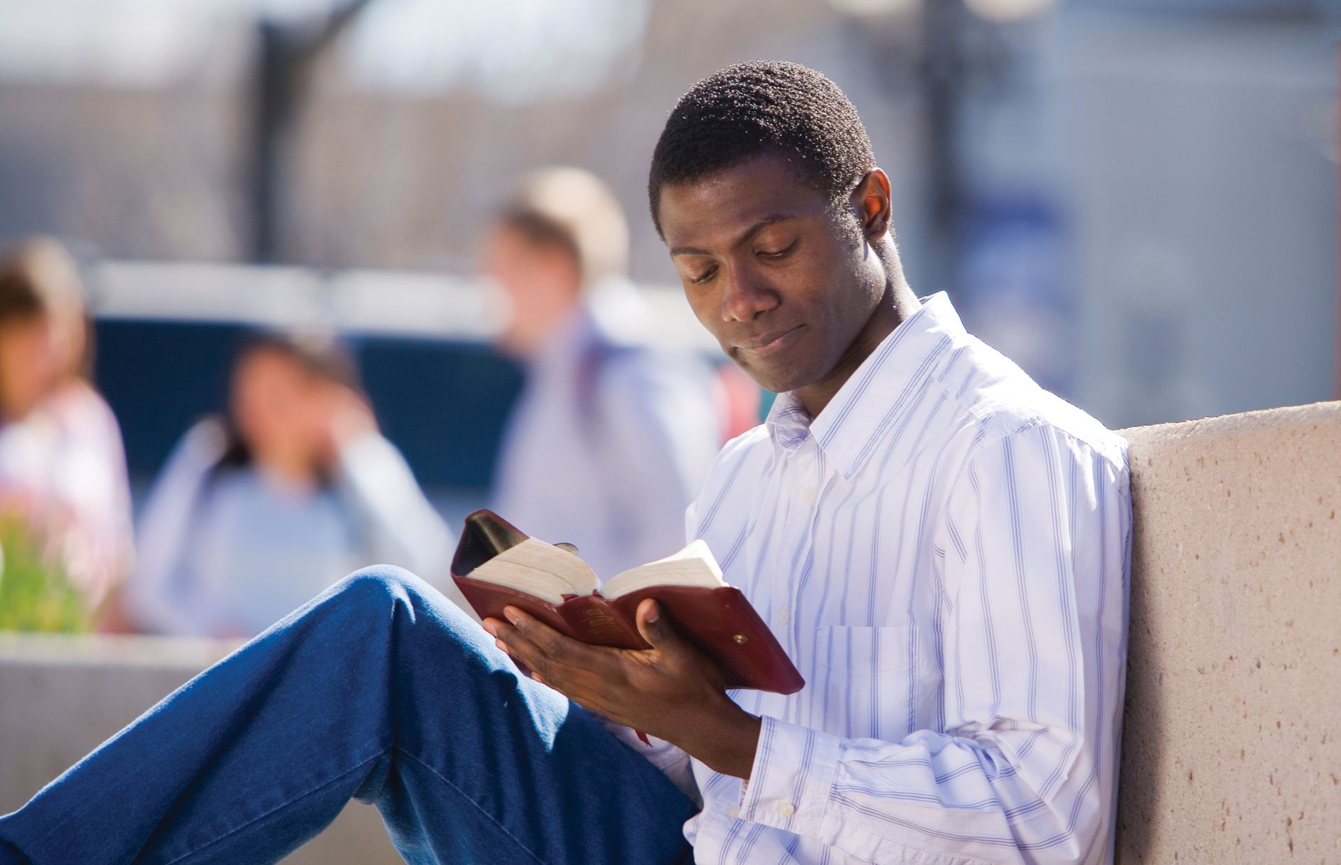A young man studying the scriptures.