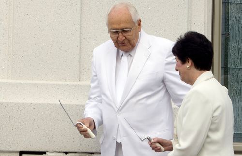 Elder L. Tom Perry and  his wife, Barbara, applying mortar to the cornerstone of the Brigham City Utah Temple, September 23, 2012.