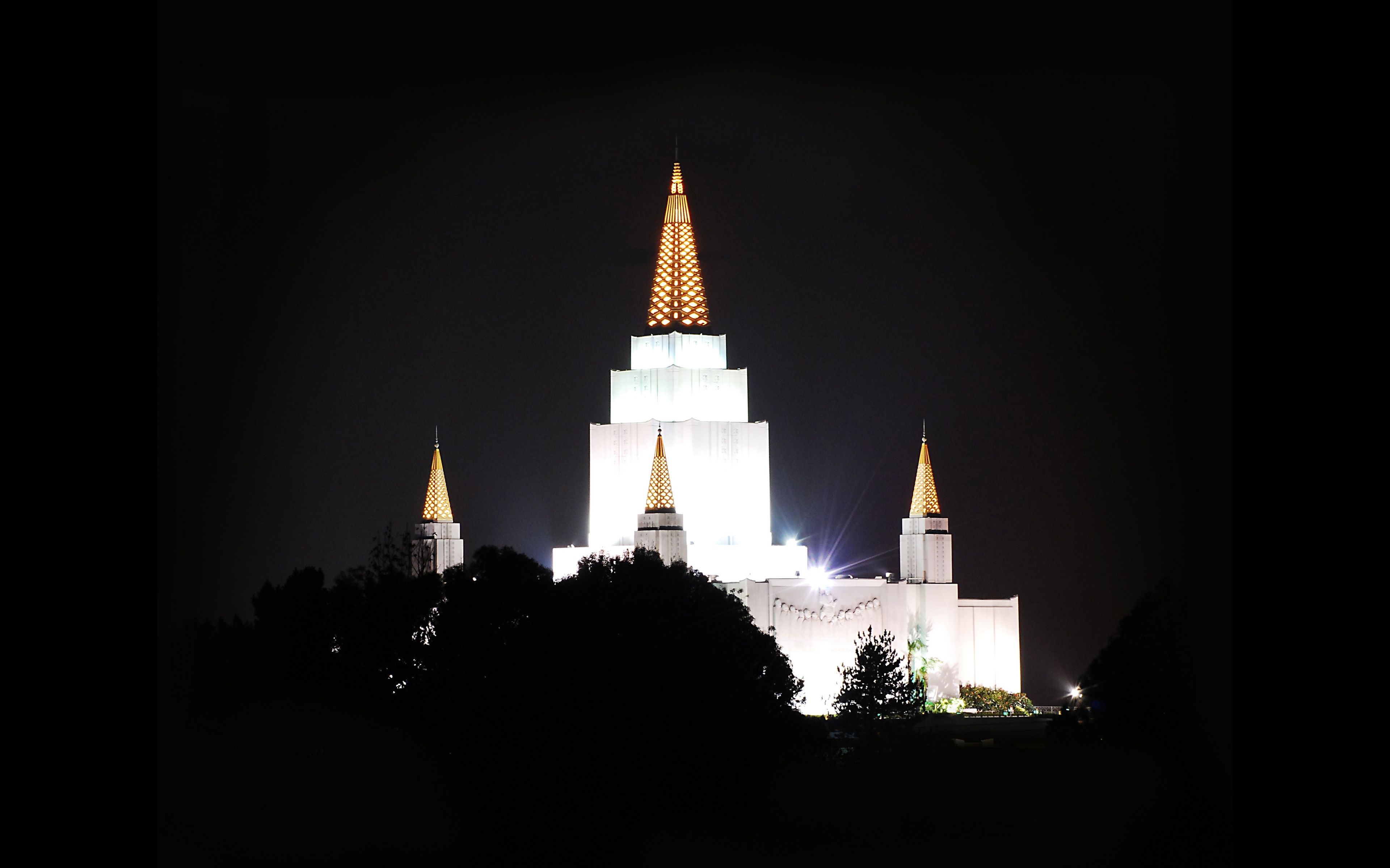 The Oakland California Temple in the evening, including scenery.