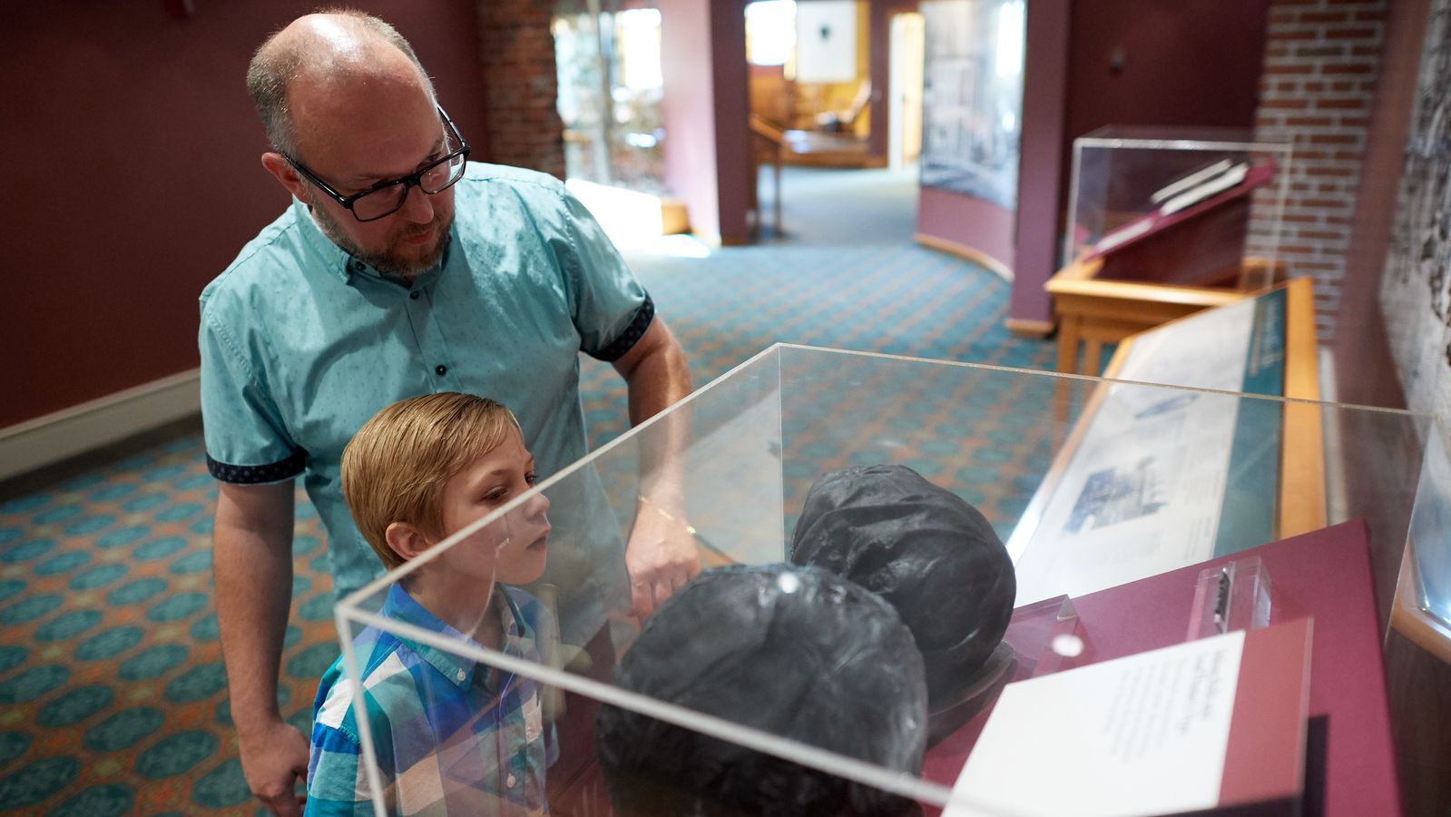 A father and son interact with various exhibits in the Book of Mormon Historic Publication Site (E. B. Grandin's Print Shop) in Palmyra, New York.